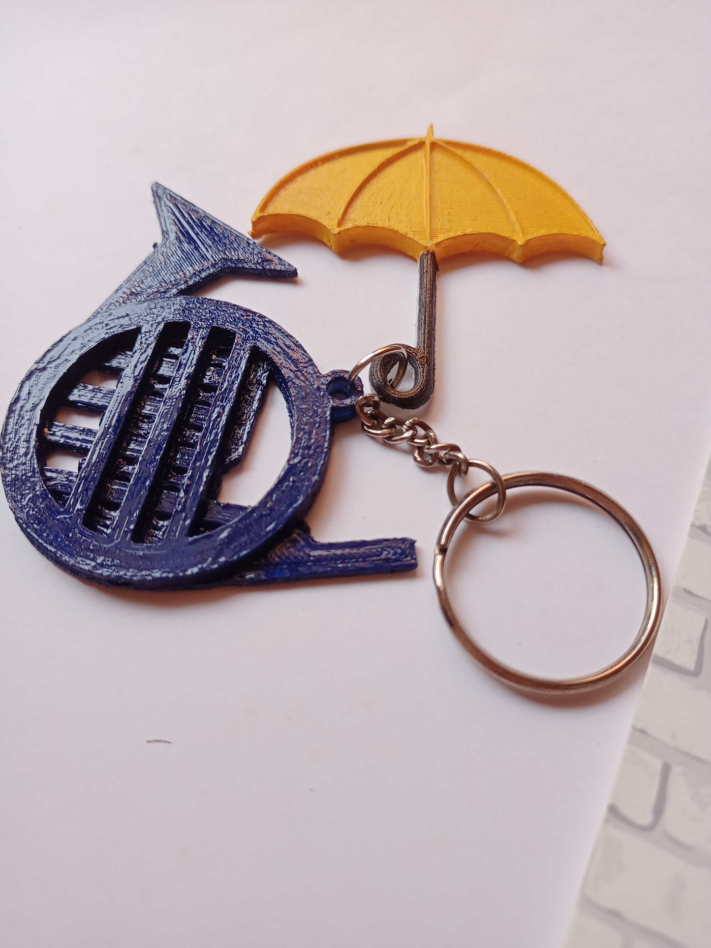 Blue french horn and umbrella keychain