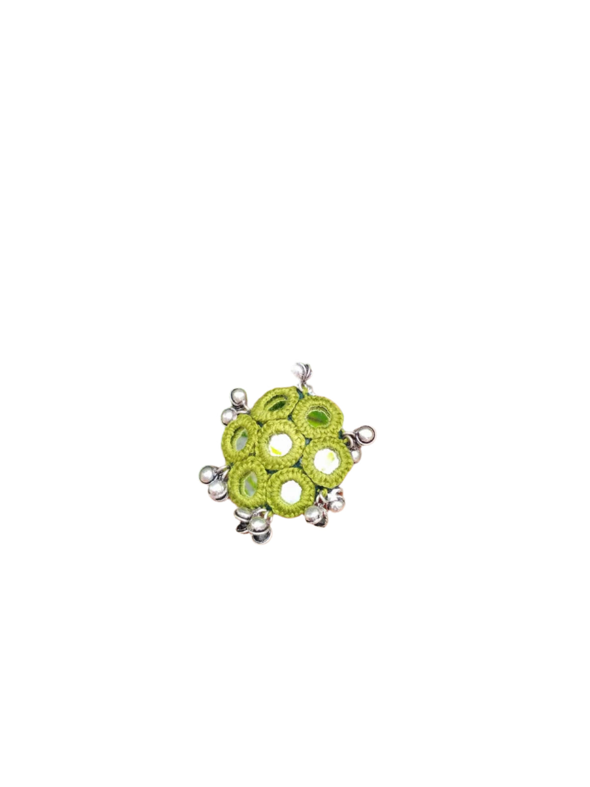 Hand wearing a green beaded ring with pink nail polish against a green leafy background