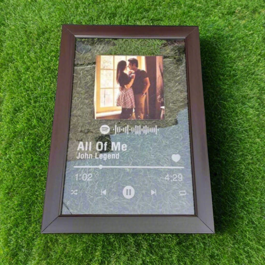 Glass like frame with wooden framing, spotify song link and a couple photo on it