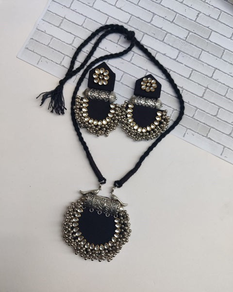 Black pendant necklace with silver charm and kundan with silver beads