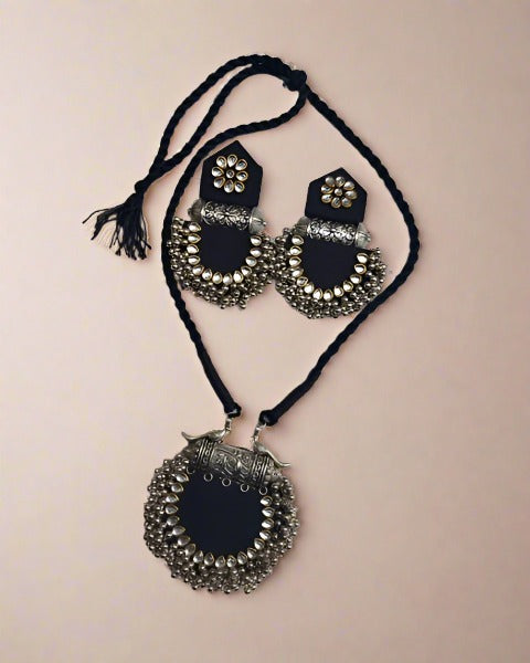 Black pendant necklace with silver charm and kundan with silver beads