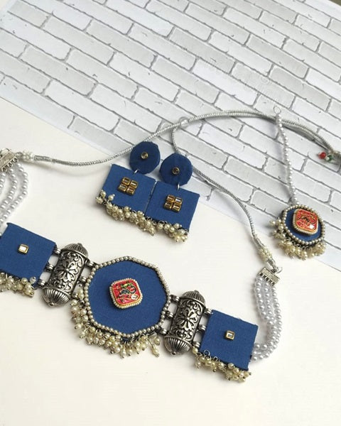 Dark blue necklace earrings and mangtika set with white beads and silver charms