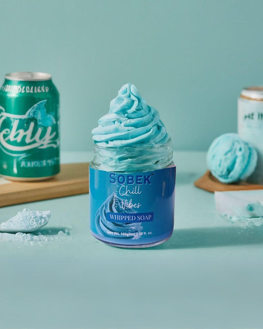 Sobek naturals blue whipped cream soap in glass jar on blue backdrop with icecream