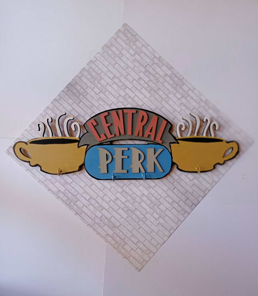 Friends TV central perk logo keyholder in pastel colors on a white wall