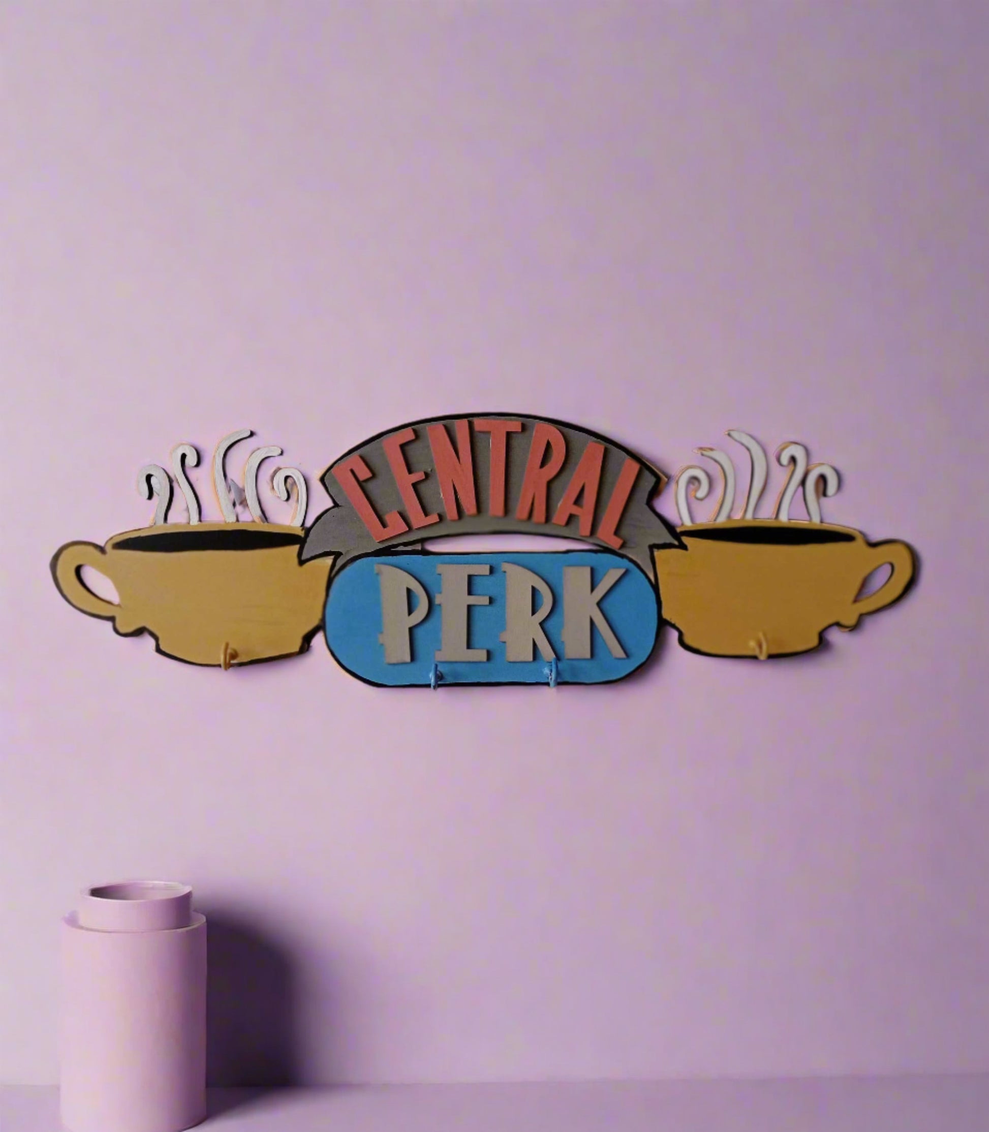 Friends TV central perk logo keyholder in pastel colors on a white wall