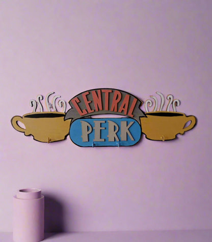 Friends TV central perk logo keyholder in pastel colors on a white wall