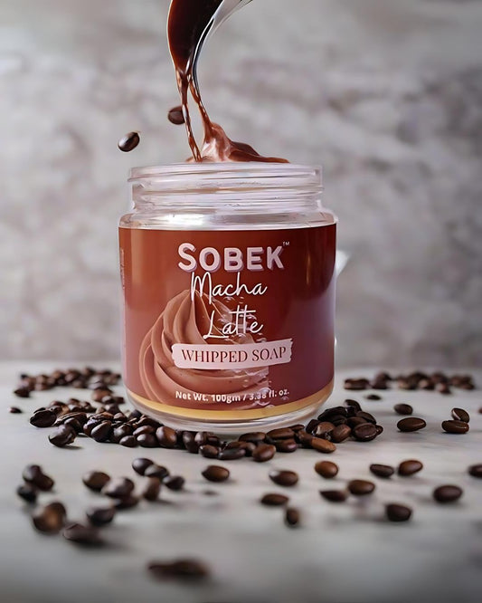 Sobek naturals macha latte coffee whipped soap on grey backdrop with coffee beans around