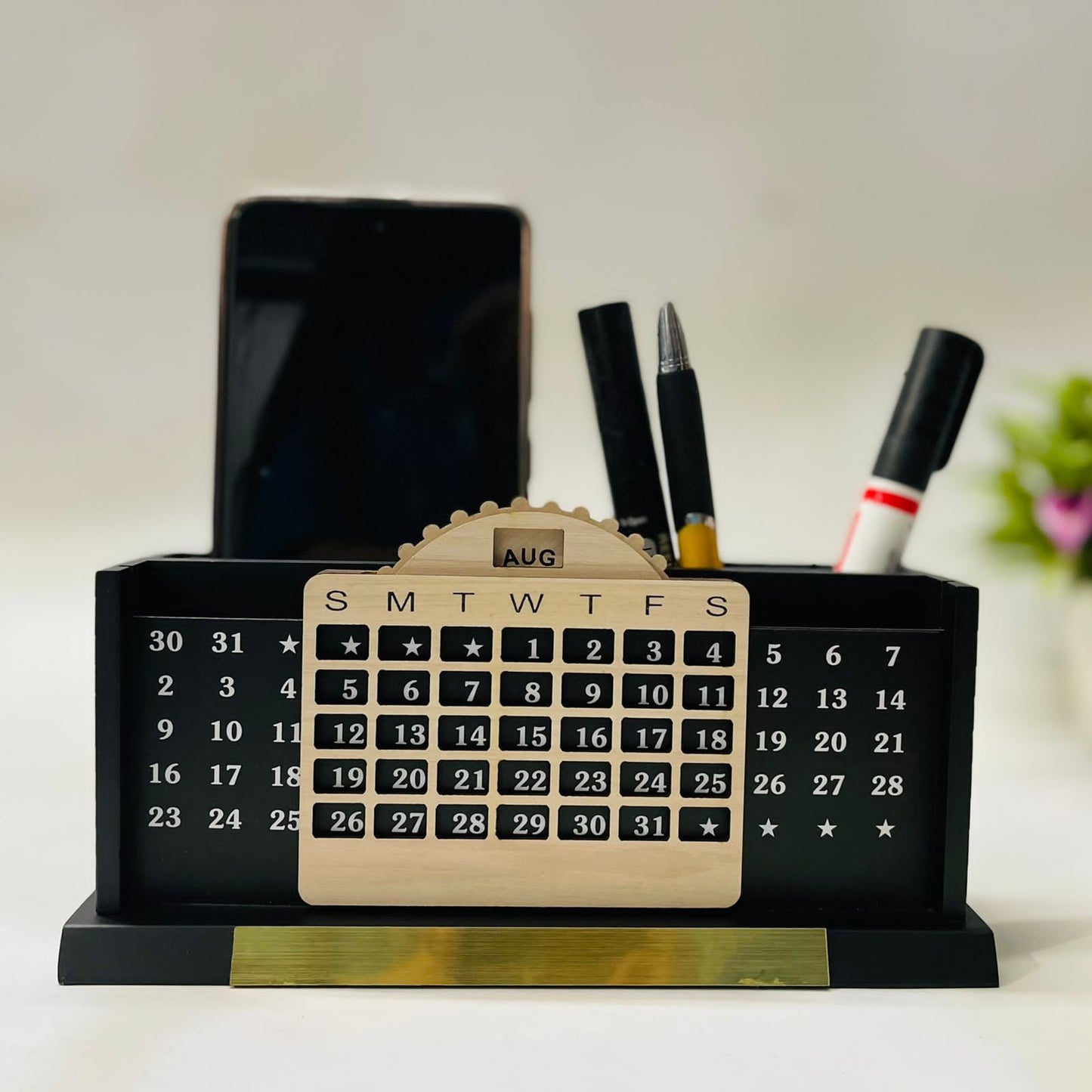 Black wooden pen and mobile stand with infinite calendar, mobile on the left and pens on right