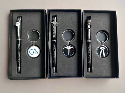 Three black boxes with customised pens and keychains inside each