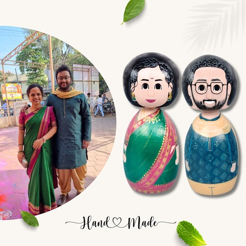Wooden peggy dolls of a couple wearing green saree and blue dhoti kurta 