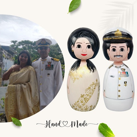 Wooden peg dolls of a couple with woman in saree and man in navy uniform 
