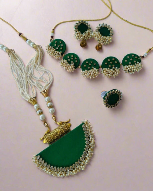 Dark green necklace, earrings, choker, ring with golden beads and tabiz on white backdrop