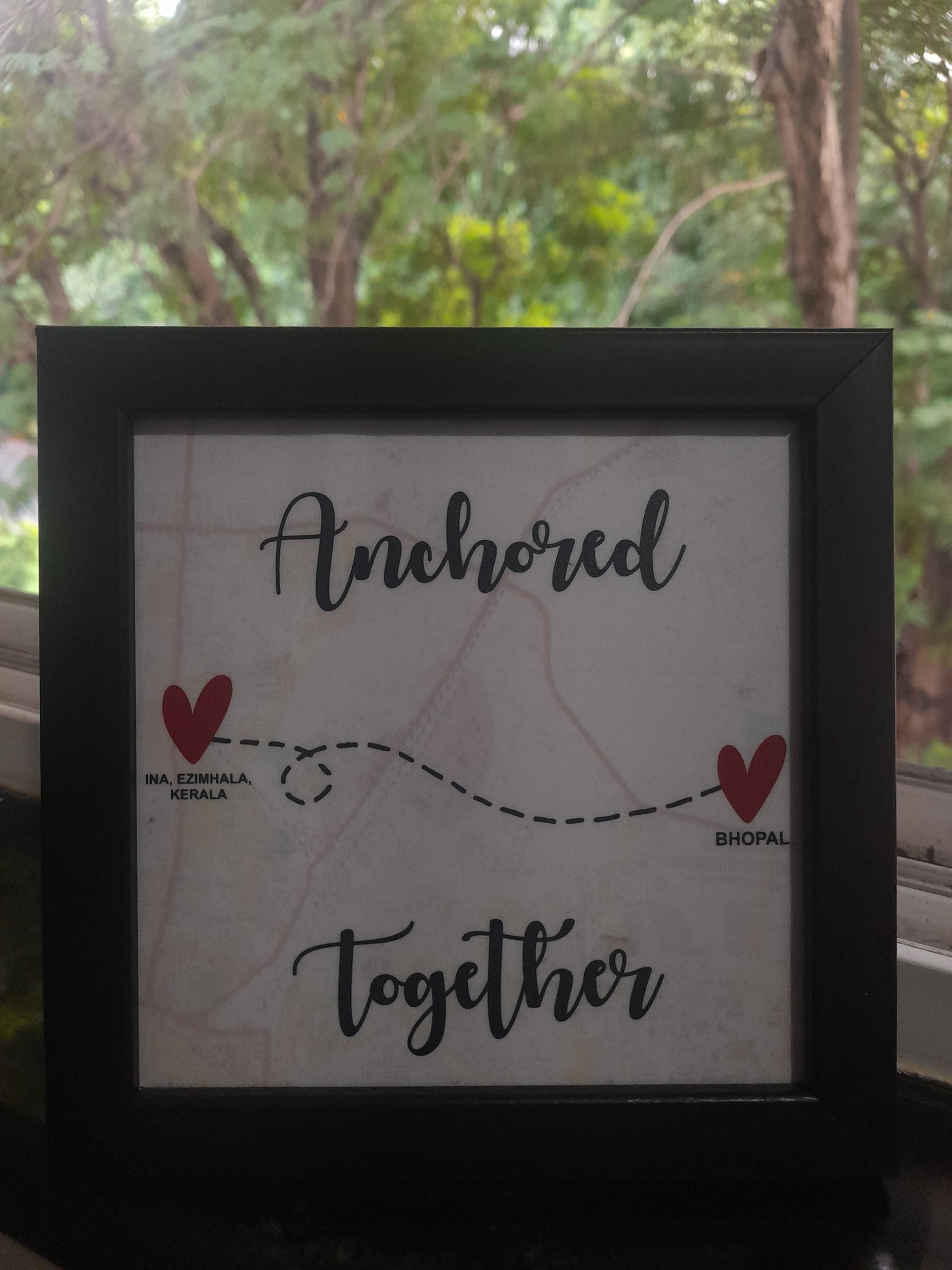 White frame with map, 2 red hearts and text with black framing 