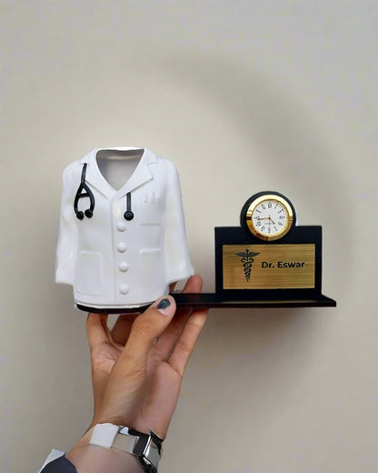 Hand holding doctor shape pen stand attached to nameplate and mini golden clock
