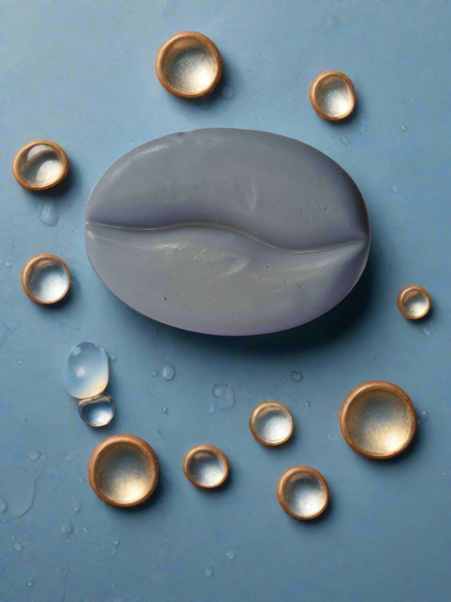 Dusky blue coffee bean shaped soap on a white backdrop