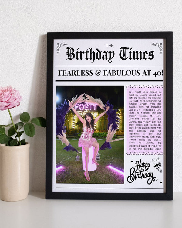 Framed birthday newspaper with a celebratory photo of a woman in a pink dress.