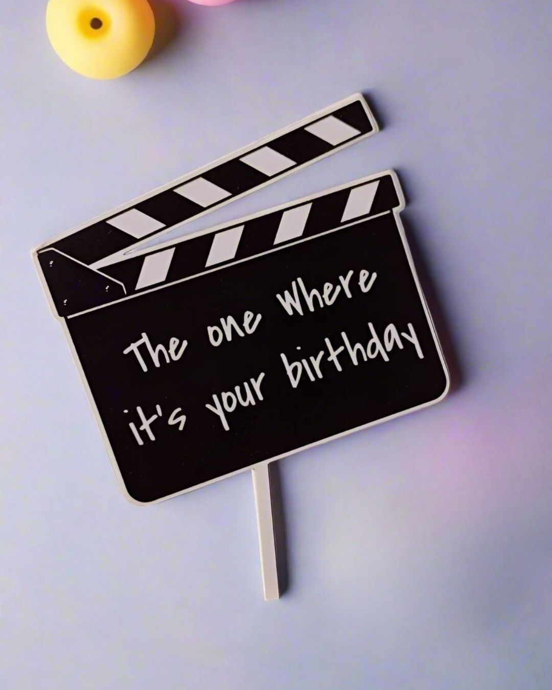 Black and white film reel friends tv show cake topper with text on it