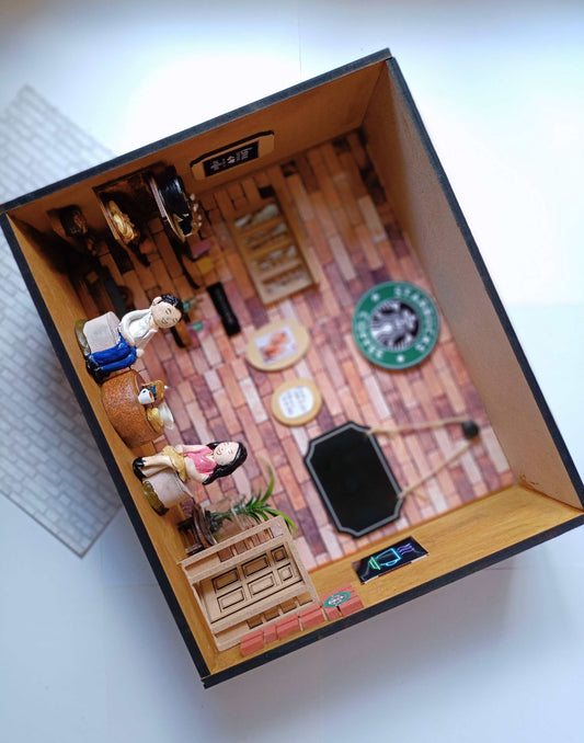 Wooden shadow box frame with starbucks miniature props and girl boy sitting happily inside