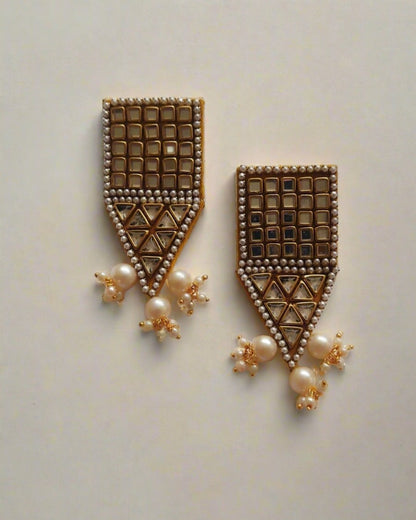 Rectangular kundan beaded jhumka earrings on white grey backdrop with pointed bottom