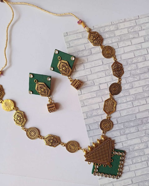 Green long golden oxidized polished necklace with green and golden earrings and kundan borders