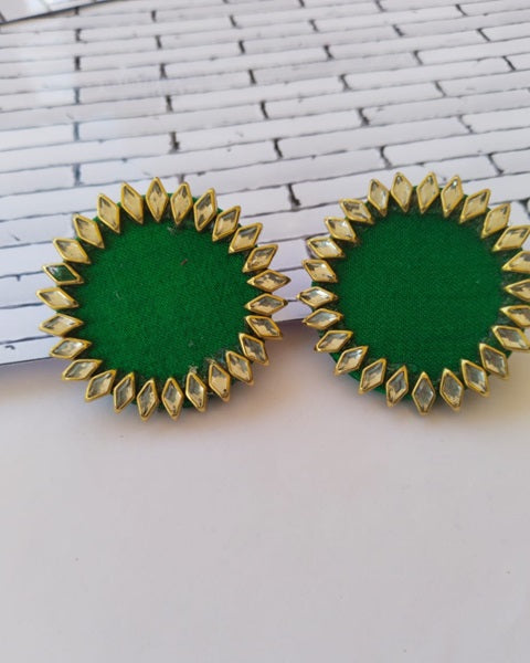 Dark green round earrings with kundan border on white backdrop