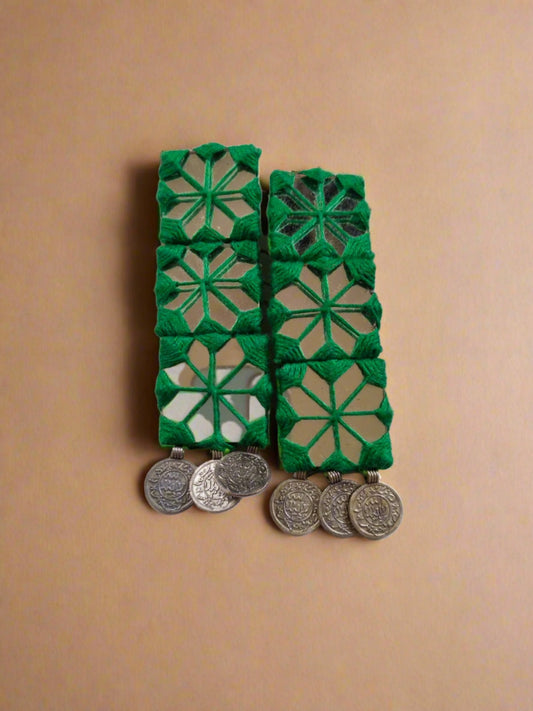 Green long rectangular earrings with mirror and silver coins on white backdrop