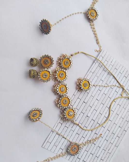 Yellow necklace, earrings, bracelet and tika set with kundan work