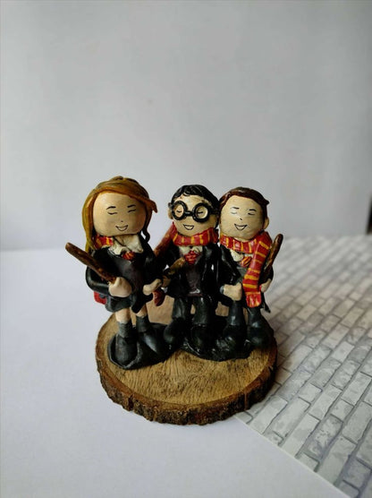 Harry potter trio clay sculpture miniature on wooden base on white grey backdrop