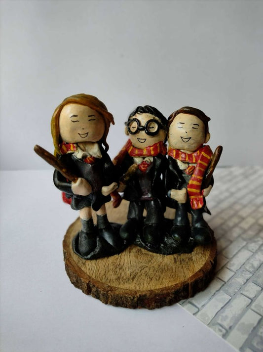 Harry potter trio clay sculpture miniature on wooden base on white grey backdrop