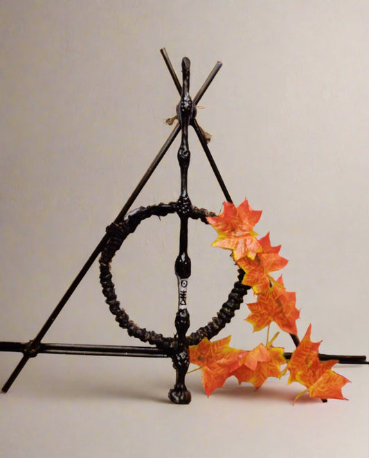 Harry potter deathly hallows sign, elder wand made with wood and decorated with orange leaves 