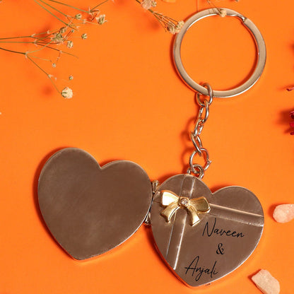Heart shape metail mini openable keychain with couple name engraved on orange background