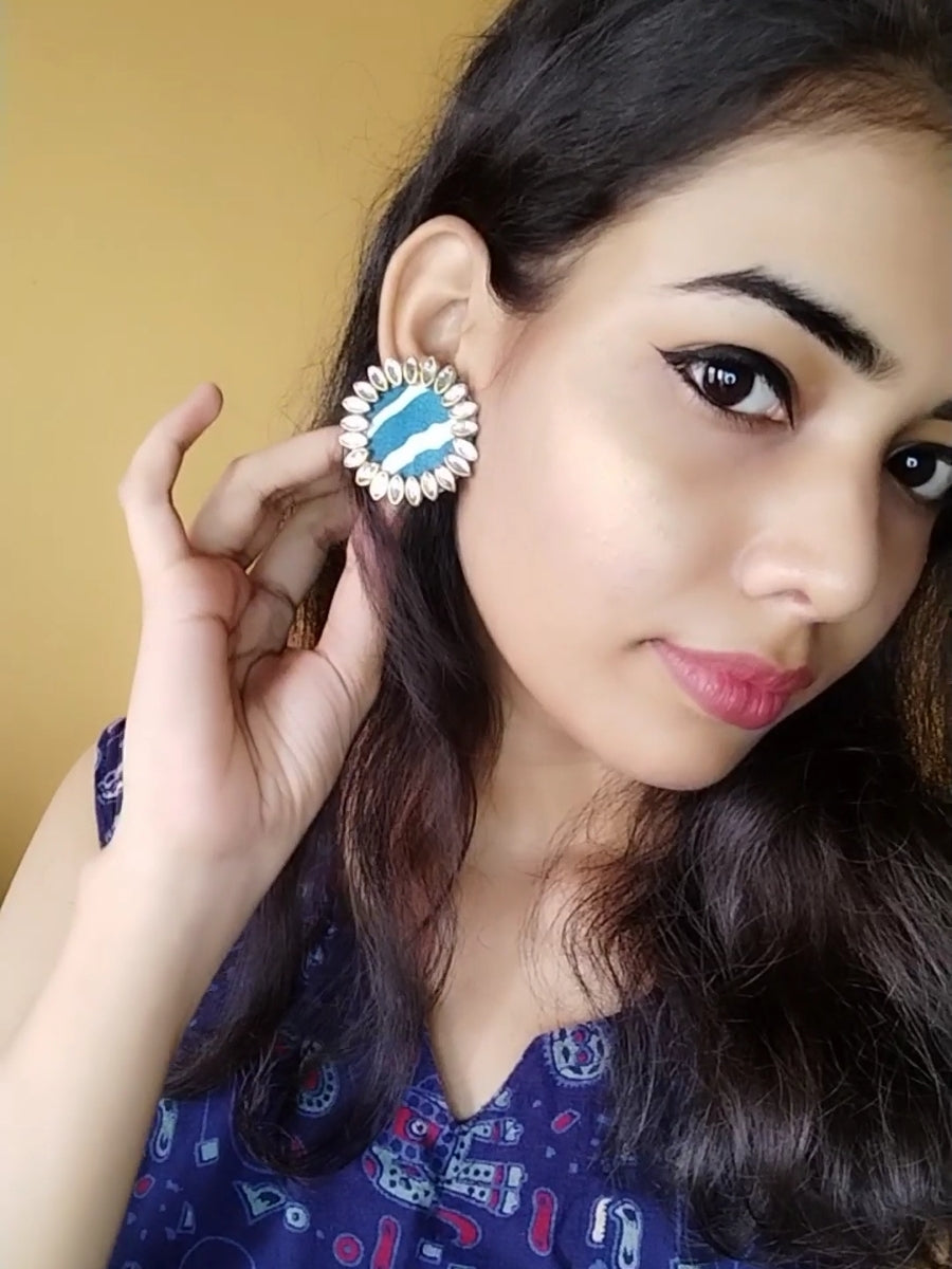 Indian girl wearing Indigo blue printed round studs with kundan border