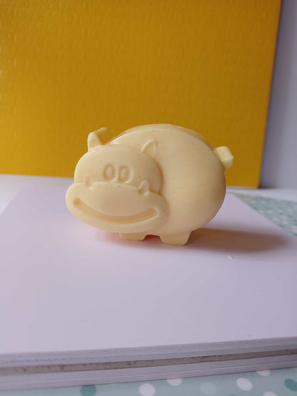 Yellow beige color pig shaped soap on white backdrop