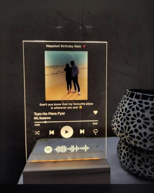 LED Spotify frame with couple picture and messages engraved on it on a table 