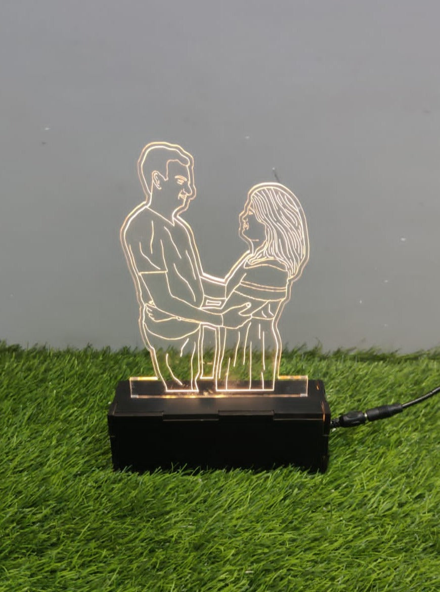 LED light sculpture frame of a couple looking at each other