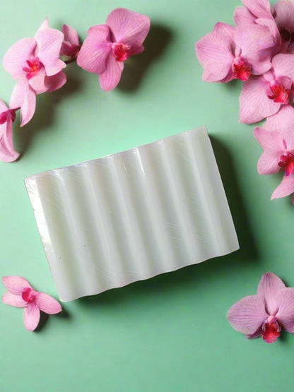 Light green rectangular soap bar on a white grey backdrop