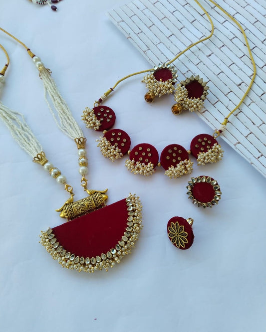 Red maroon necklace, earrings, choker, ring with golden beads and tabiz on white backdrop