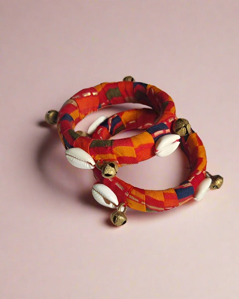 Printed orange bangles with golden ghungroo and sea shells