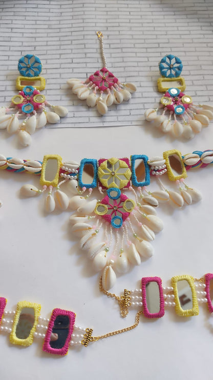 Yellow pink and red with mirror work, white pearls, sea shells necklace, earrings, tika and bracelet 