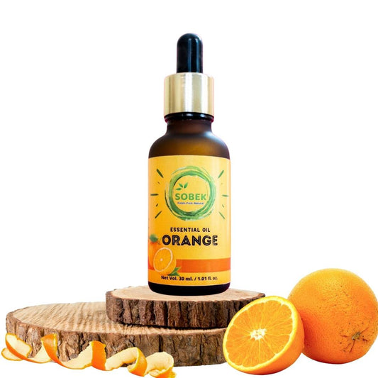Sobek orange essential oil in brown glass jar on wooden coasters and oranges around