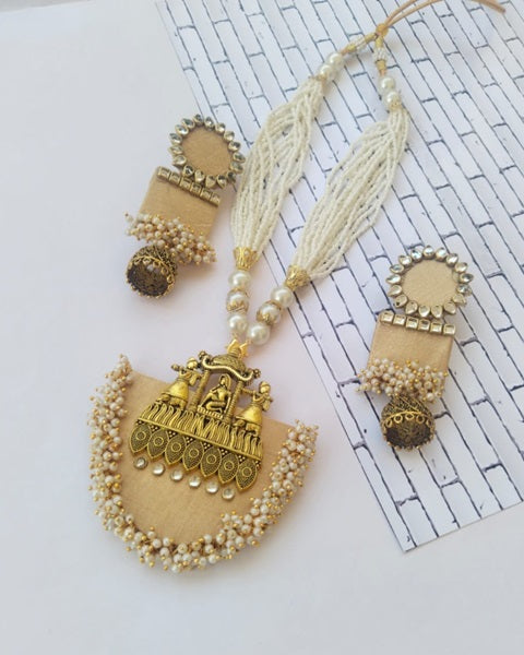 Pastel yellow necklace with traditional golden charm and kundan rectangular earrings