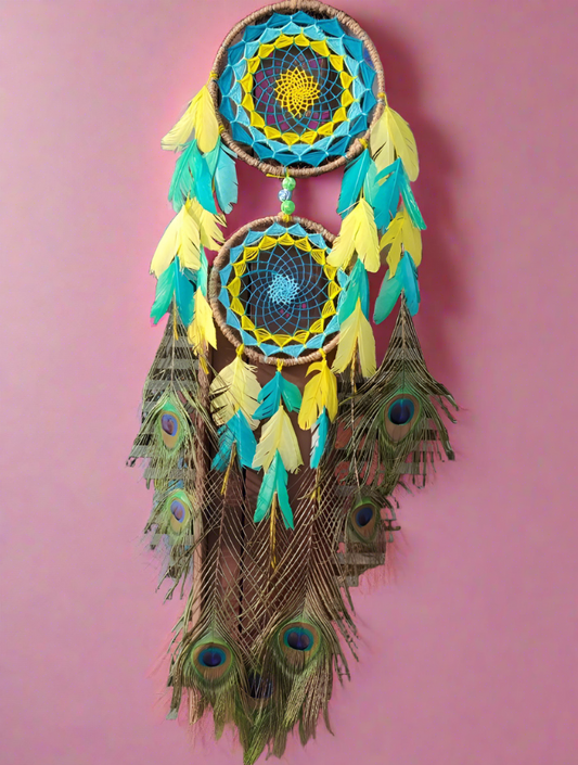 Peacock feathers alike dreamcatcher on pink wall 