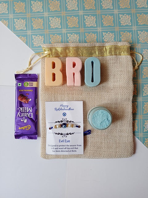 Bro alphabets soaps in pink and blue with dairy milk chocolate, blue whipped soap and evil eye rakhi