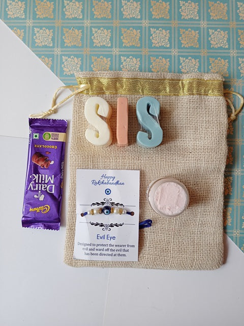 Sis alphabets soaps in pink and blue with dairy milk chocolate, pink whipped cream soap and evil eye rakhi