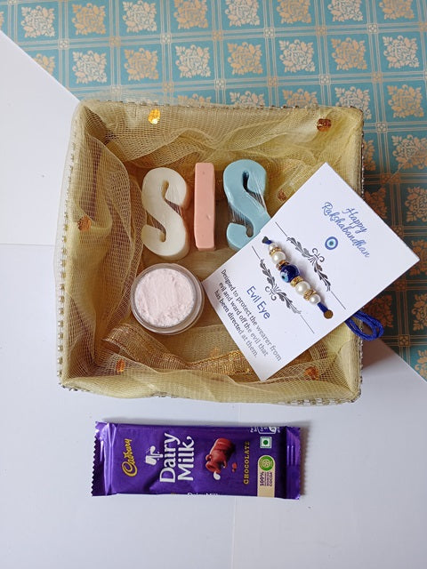 Sis alphabets soaps with pink whipped cream soap jar, rakhi and dairy milk chocolate inside a box
