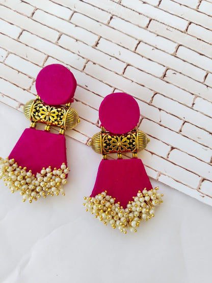 pink earrings with golden tabiz, white beads on white backdrop