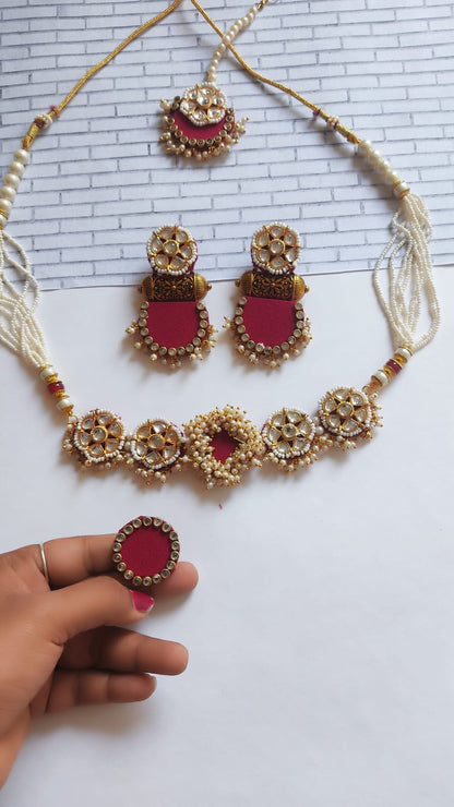 Pink and golden necklace, earrings ring and tika set with white beads and kundan