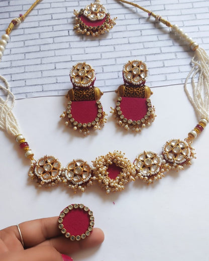 Pink and golden necklace, earrings ring and tika set with white beads and kundan