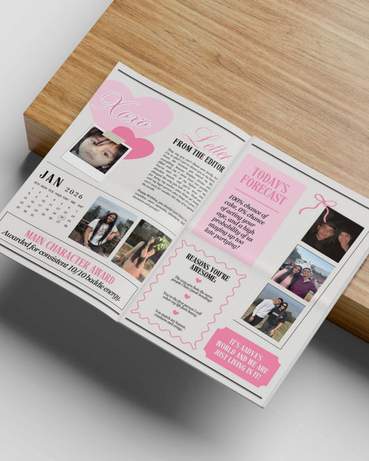 Open magazine or book with pink and white design on a wooden surface