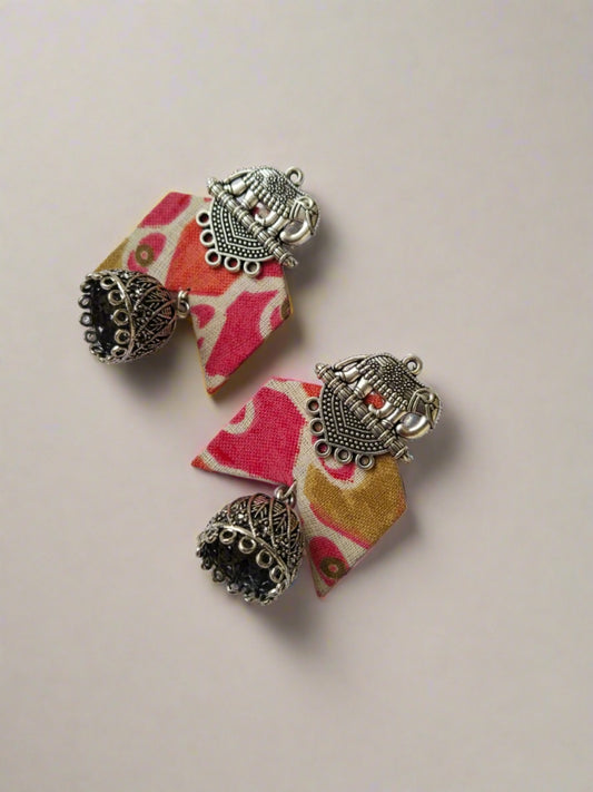 Pink floral printed earrings with silver elephant charm on top on white backdrop